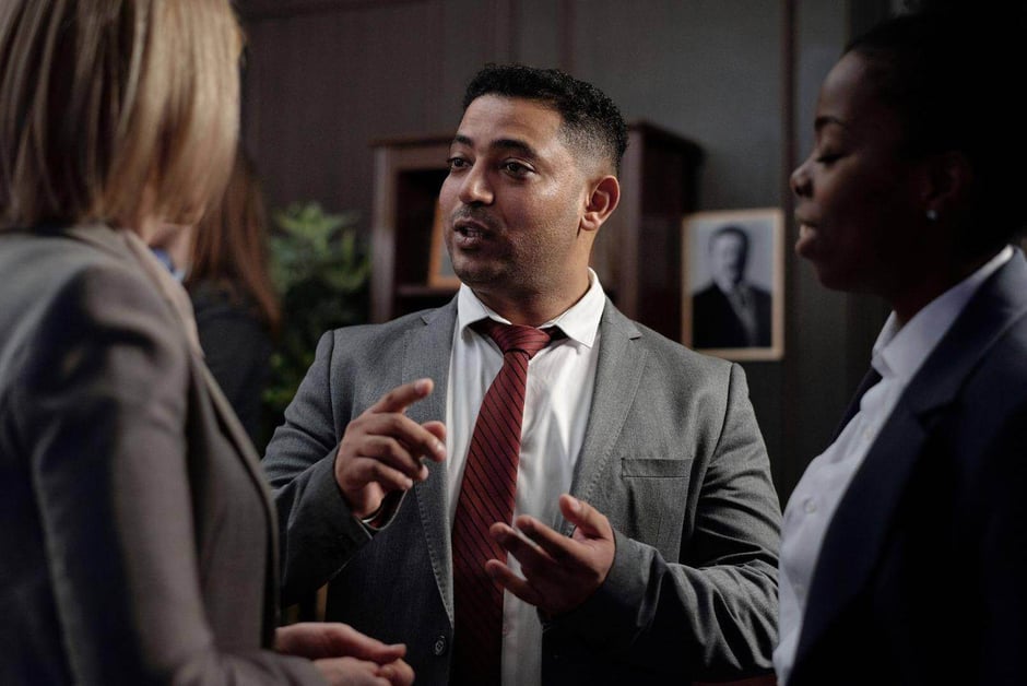 A lawyer discussing cases with other lawyers in Tuskegee, Alabama