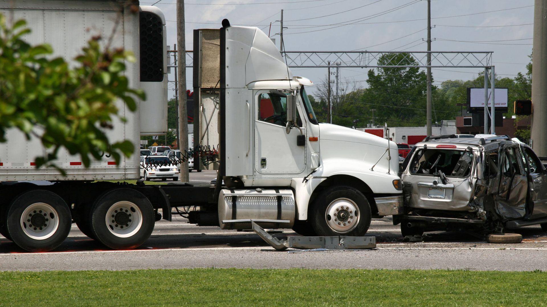 A minivan that has been totaled by a rear-end collision with a semi-truck in Albertville, Alabama